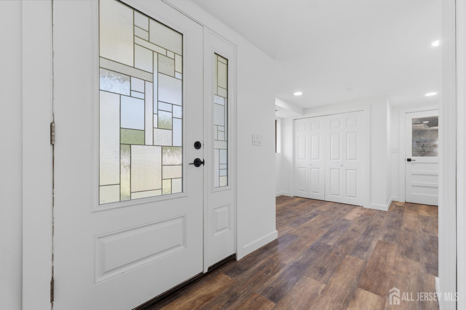 12 Daniel Road Spotswood, NJ 08884 - Photo 18 of 27 a view of an empty room with wooden floor and windows
