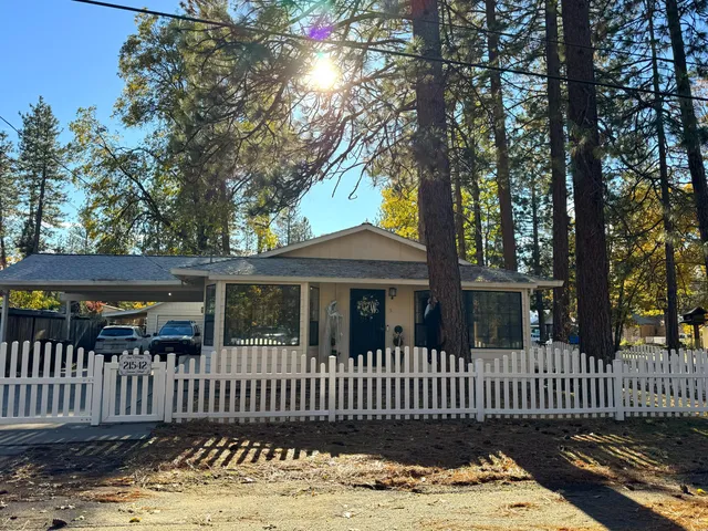 a living room with furniture and a flat screen tv with wooden floor