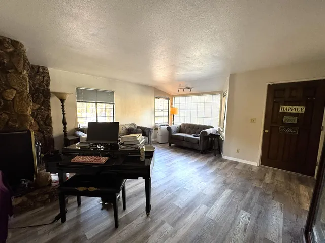 a bedroom with a bed closet and wooden floor