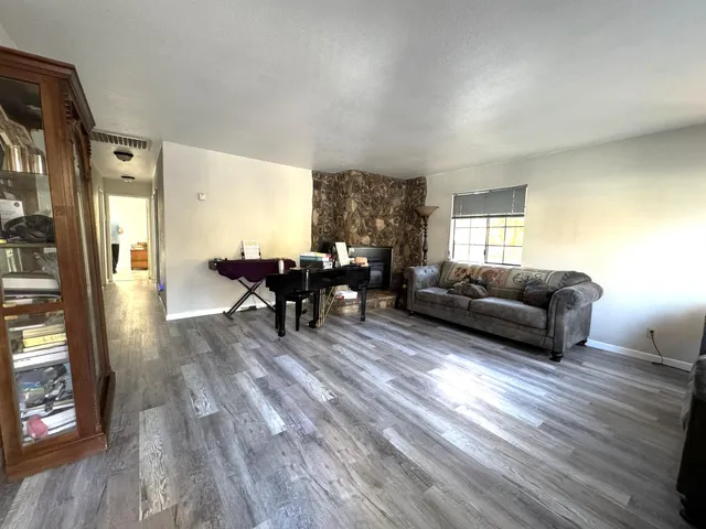 a living room with furniture and a mirror