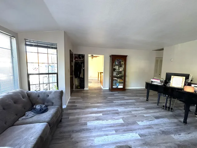 a view of a patio with table and chairs with wooden floor and fence