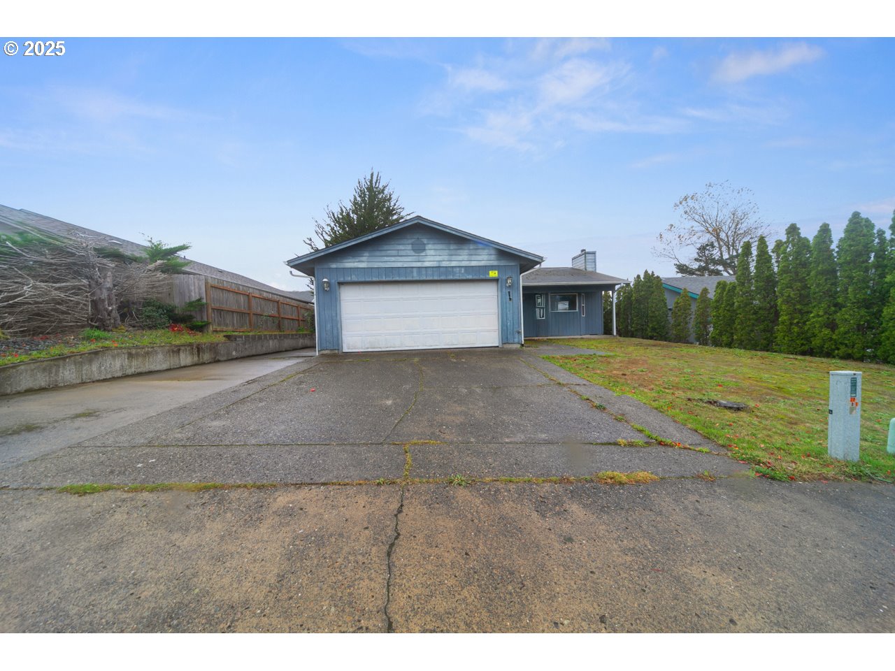 a view of a house with a yard and garage