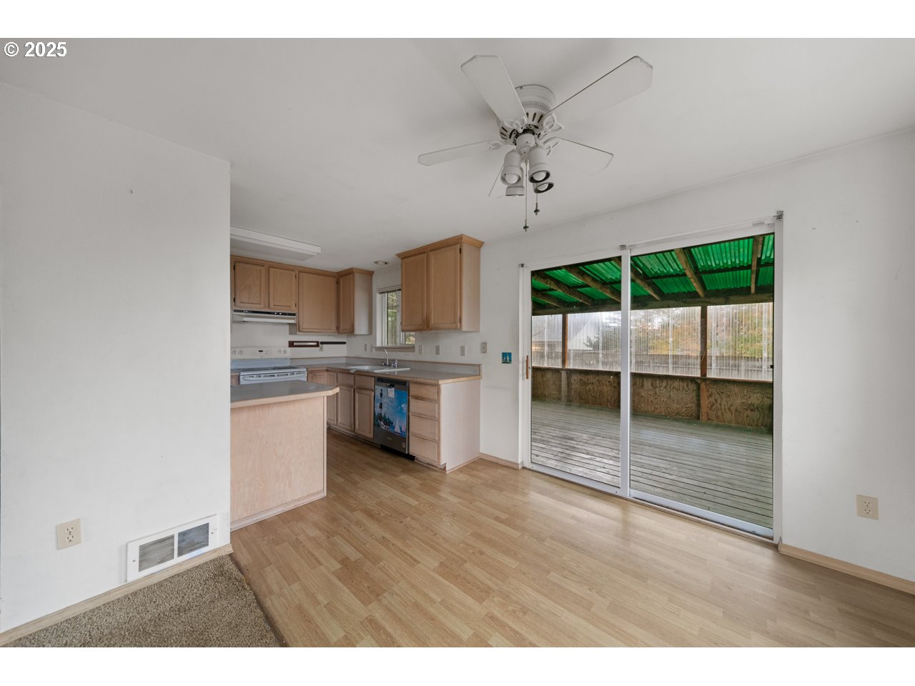 1924 Garfield Street North Bend, OR 97459 - Photo 6 of 33 a open kitchen with kitchen island a sink appliances and cabinets