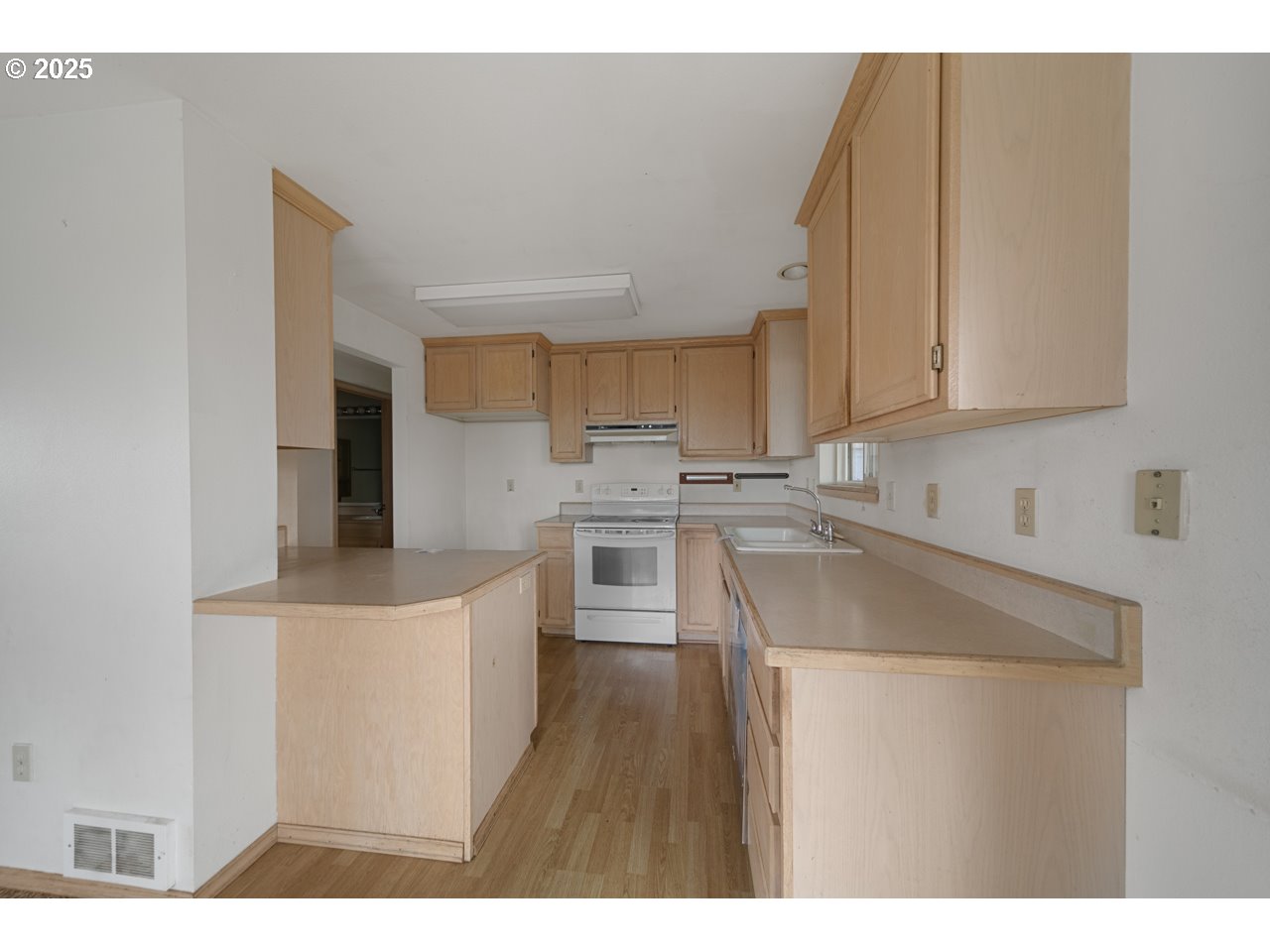 1924 Garfield Street North Bend, OR 97459 - Photo 8 of 33 a kitchen with cabinets a sink and white appliances