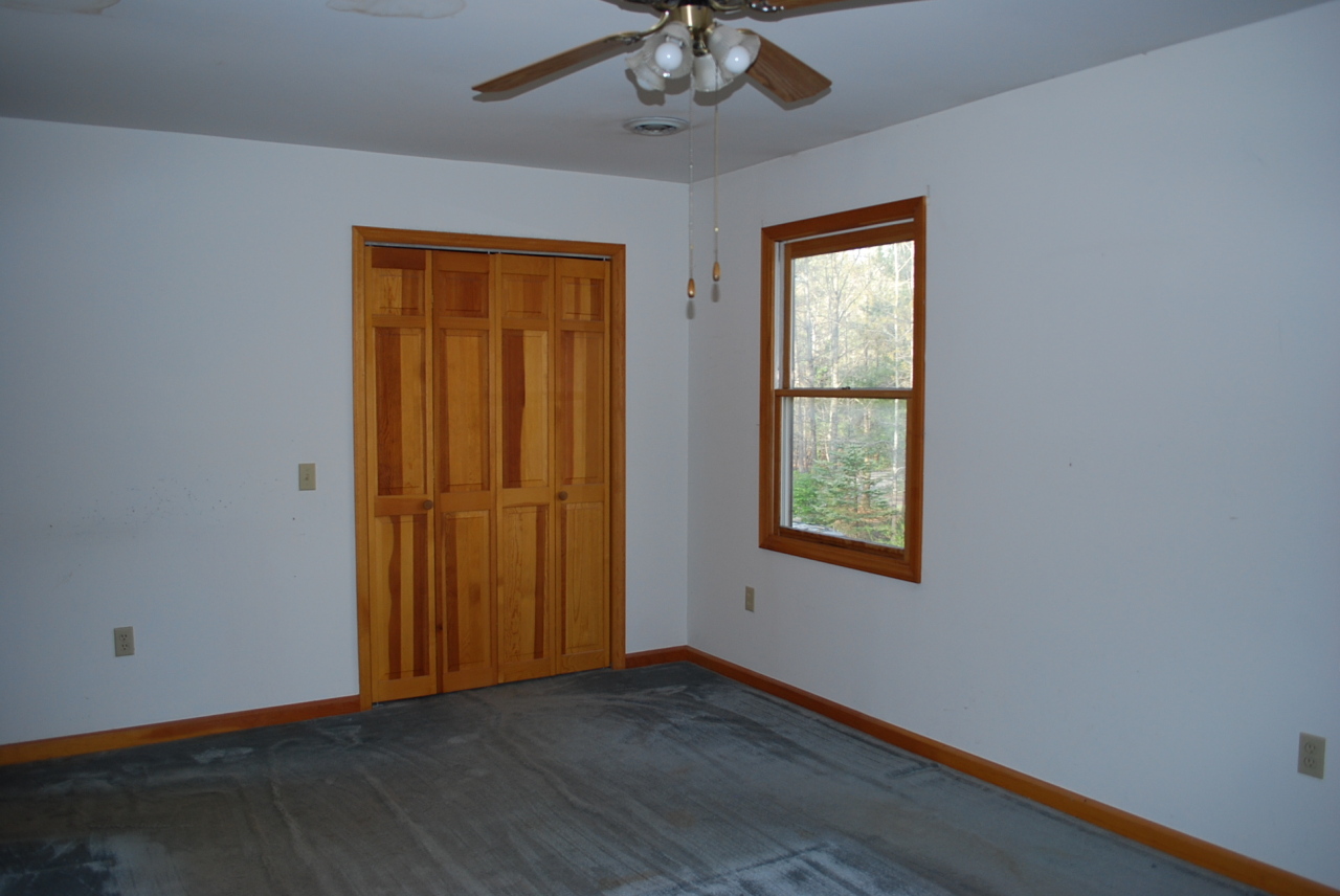 444 Iron Ridge Road Rocky Mount, VA 24151 - Photo 17 of 34 a view of an empty room with wooden floor and a window