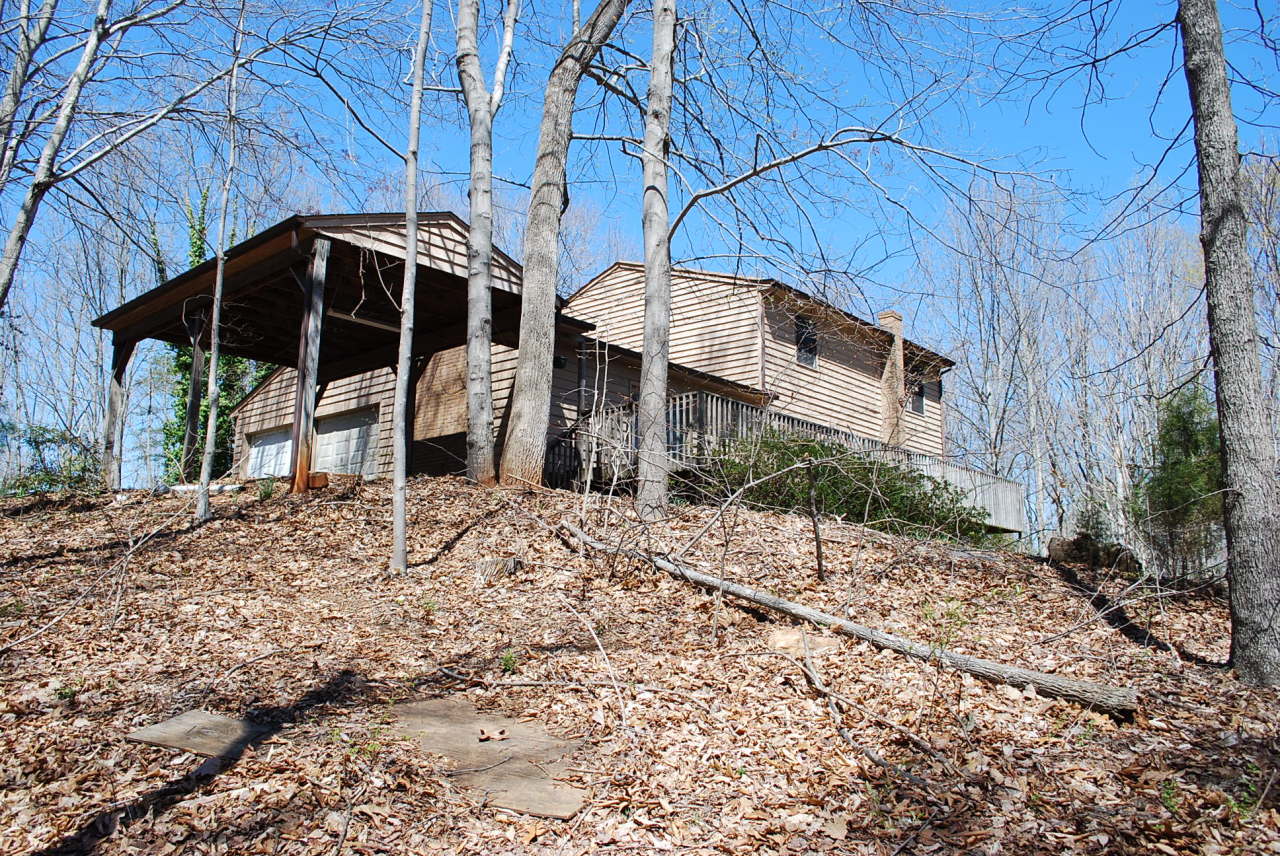 444 Iron Ridge Road Rocky Mount, VA 24151 - Photo 34 of 34 a view of a wooden house with a yard