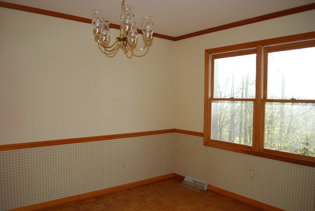 444 Iron Ridge Road Rocky Mount, VA 24151 - Photo 8 of 34 a view of a room with a large window a chandelier fan and wooden floor