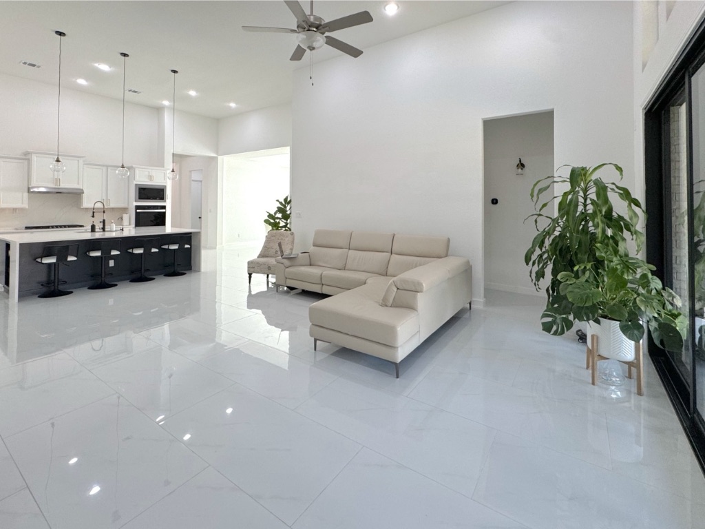 213 Camille Street Leander, TX 78641 - Photo 12 of 27 Living area with a towering ceiling, recessed lighting, a ceiling fan, and light marble finish floors
