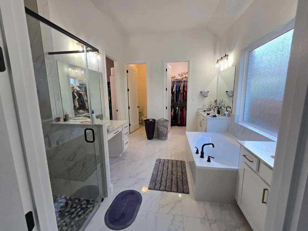 213 Camille Street Leander, TX 78641 - Photo 20 of 27 Full bathroom featuring vanity, a marble finish shower, a walk in closet, a garden tub, and light marble finish flooring