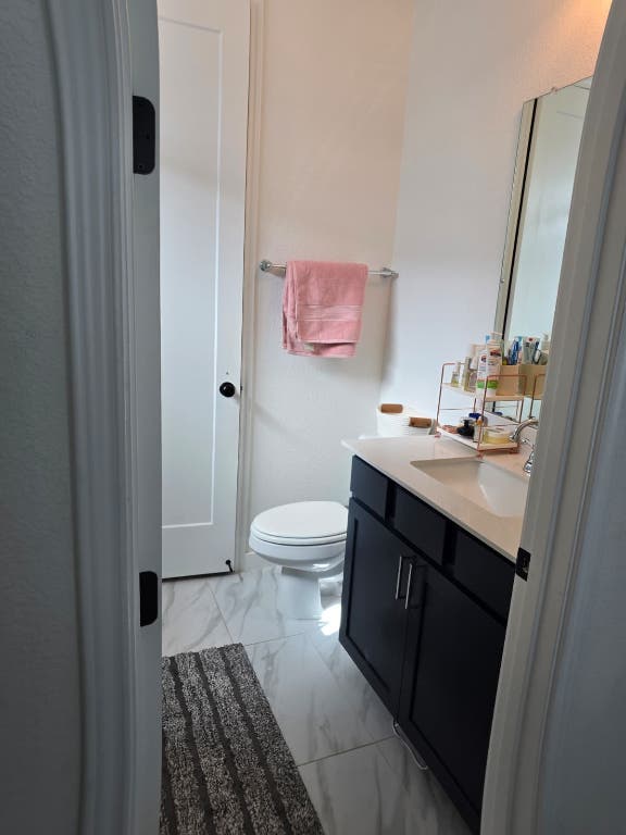 213 Camille Street Leander, TX 78641 - Photo 23 of 27 Half bath featuring vanity and light marble finish flooring