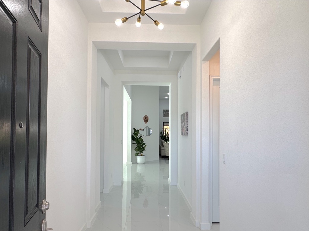 213 Camille Street Leander, TX 78641 - Photo 4 of 27 Corridor featuring a chandelier and a raised ceiling
