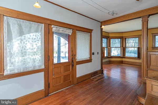 a view of a livingroom with wooden floor and a fireplace
