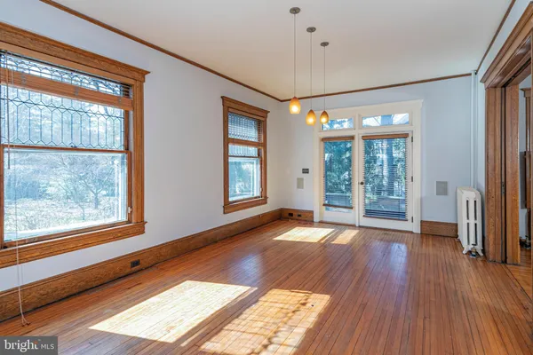 a view of an entryway with wooden floor and windows