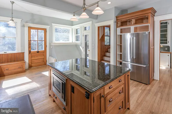 a kitchen with granite countertop a stove and a sink