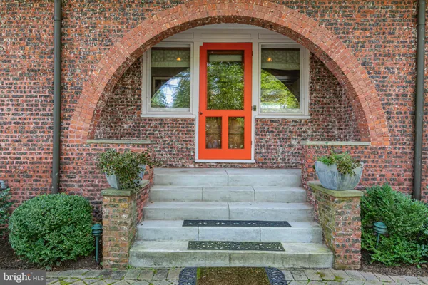 a front view of a house with plants