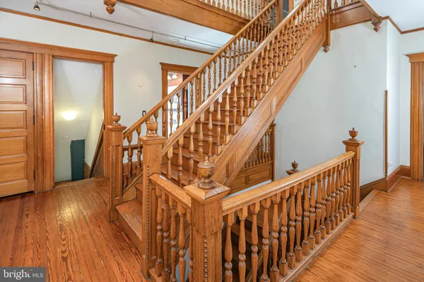 a view of entryway with wooden floor and windows