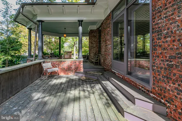 a view of a porch with wooden floor and outdoor space