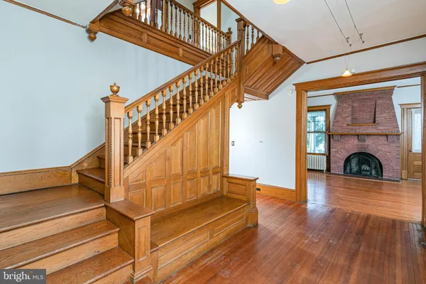 a view of entryway with wooden floor and stairs