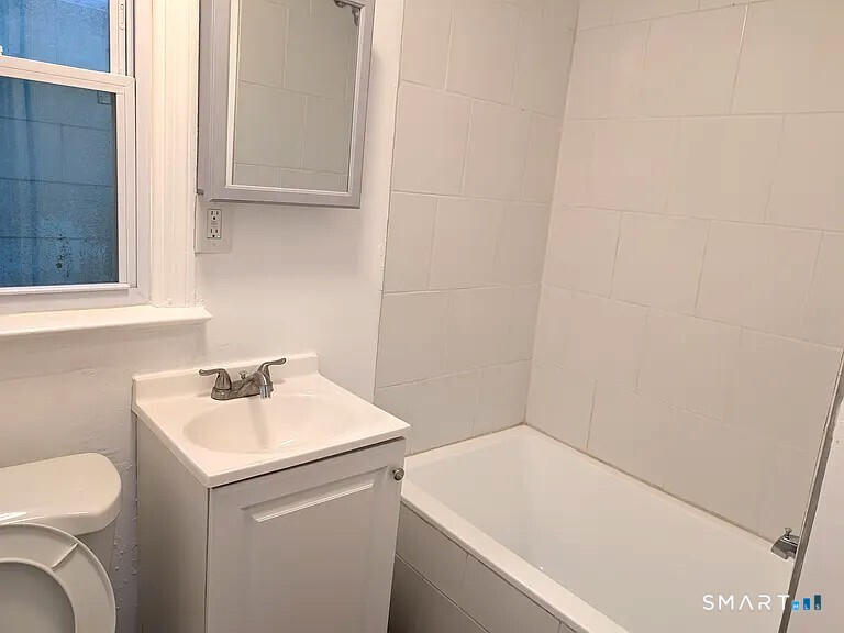 64 Liberty Street New Haven, CT 06519 - Photo 4 of 7 a bathroom with a sink and a toilet