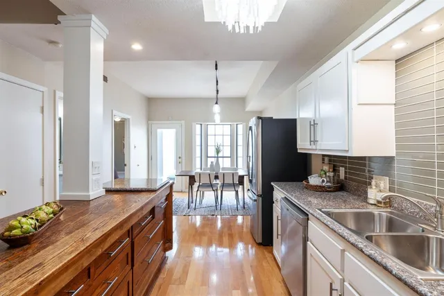 a kitchen with granite countertop a sink stove and cabinets