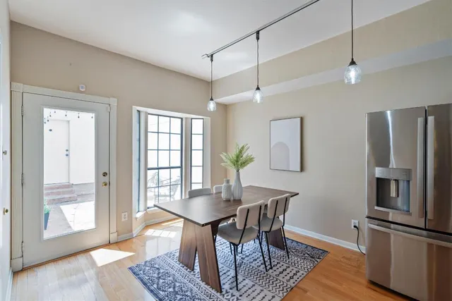 a view of a dining room with furniture window and wooden floor