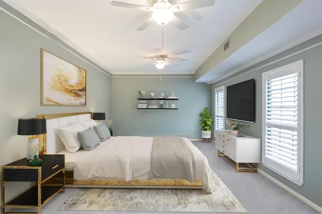 a bedroom with a large bed and a chandelier