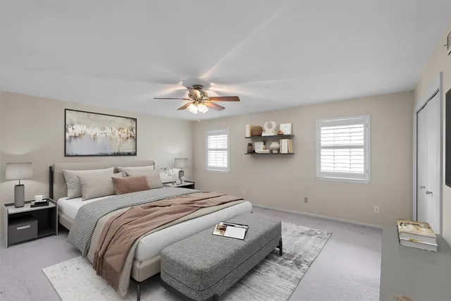a bedroom with a large bed and a chandelier