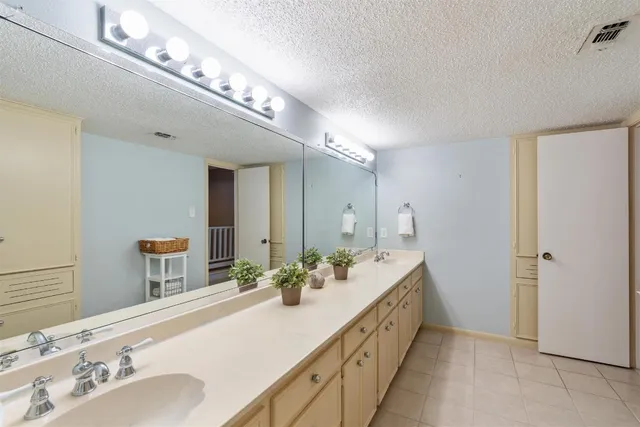 a bathroom with a double vanity sink and a mirror