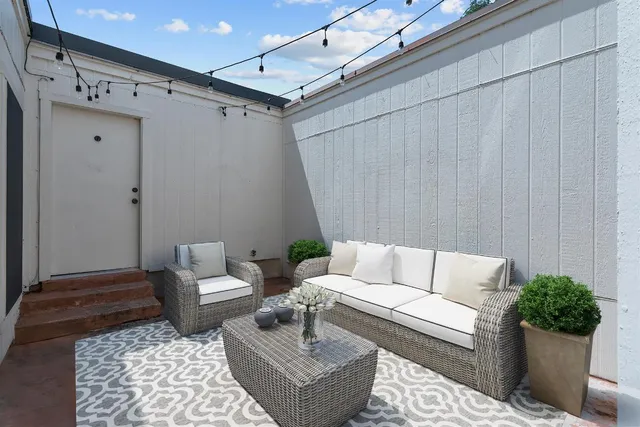 a living room with furniture and a rug