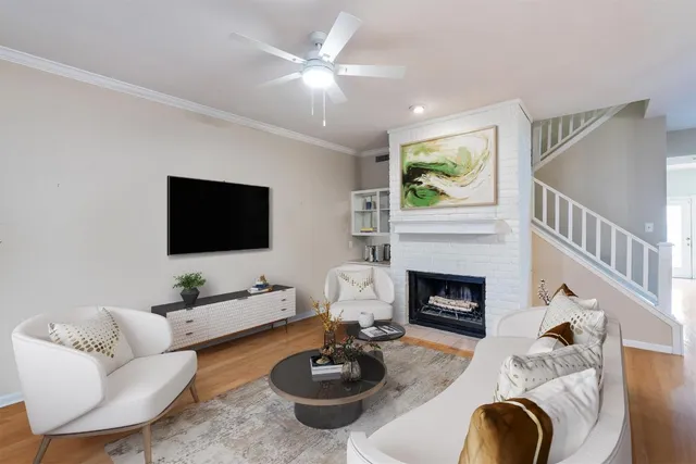 a living room with furniture a fireplace and a flat screen tv