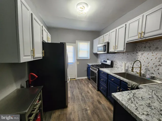 a kitchen with stainless steel appliances granite countertop a refrigerator sink and cabinets
