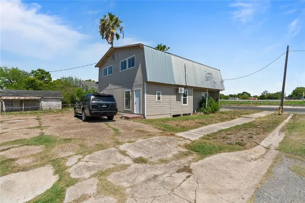 a view of a house with truck parked on the road