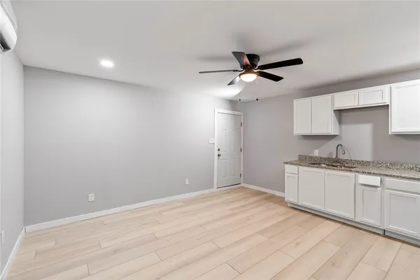 a kitchen with granite countertop a sink stainless steel appliances and cabinets