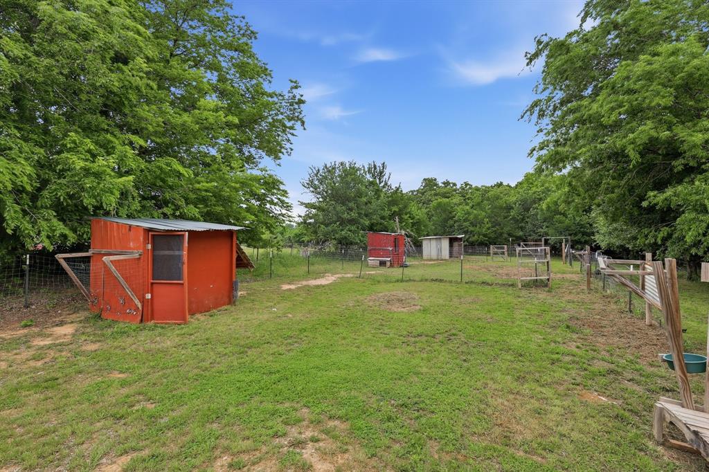 767 East Barry Street Azle, TX 76020 - Photo 16 of 40 The property offers a spacious yard with green grass and mature trees