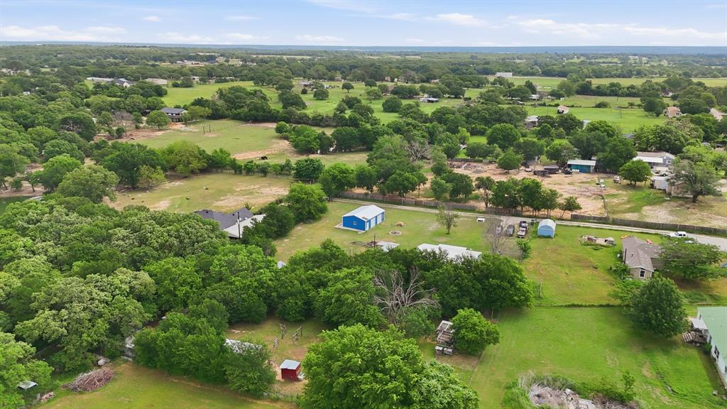 767 East Barry Street Azle, TX 76020 - Photo 8 of 40 Expansive lot with lush green fields and mature trees