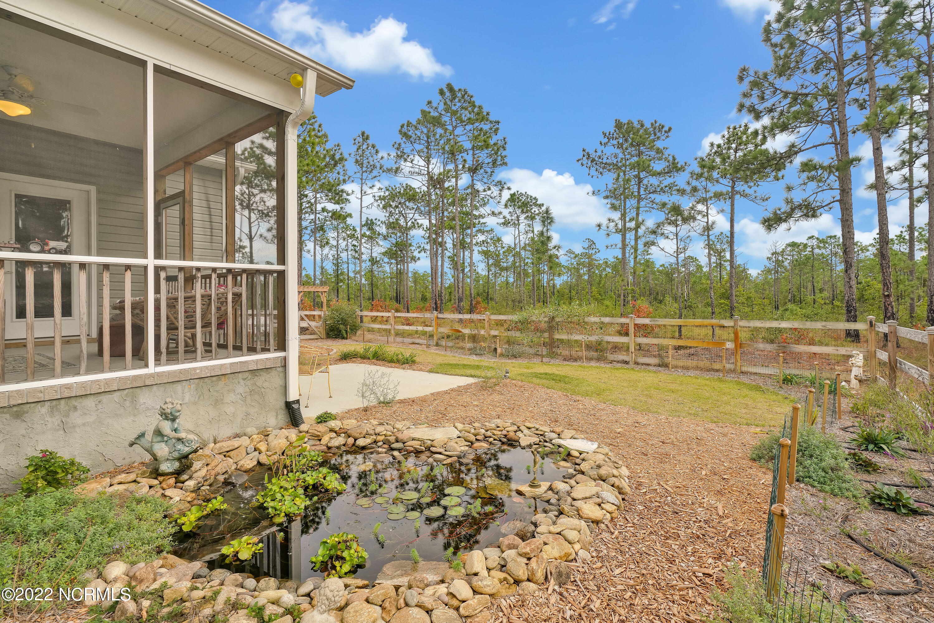 1663 Pinnacle Parkway Hampstead, NC 28443 - Photo 32 of 53 Screen Porch and Backyard