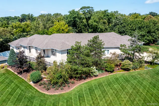 an aerial view of a house with a yard