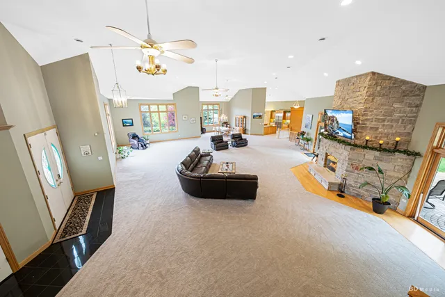 a view of a bedroom with a bed and wooden floor
