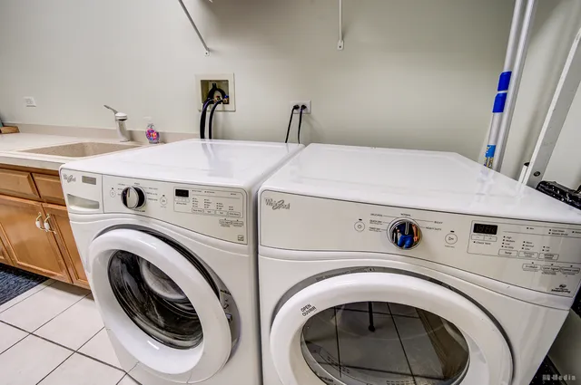 a front view of house with yard and trees around