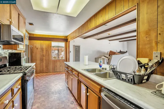 a kitchen with sink stove and cabinets