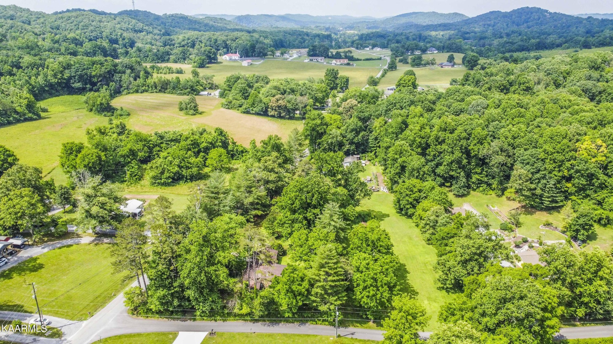 1104 Blockhouse Valley Road Clinton, TN 37716 - Photo 38 of 56 a view of a lush green hillside and houses
