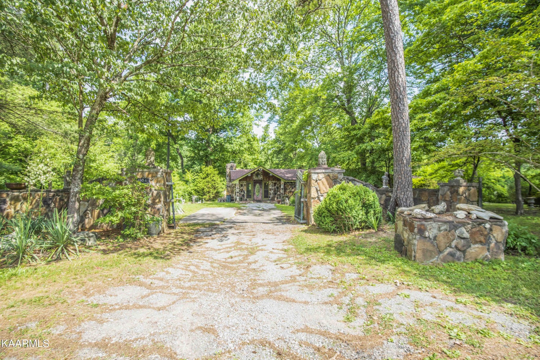 1104 Blockhouse Valley Road Clinton, TN 37716 - Photo 42 of 56 a view of a yard with plants and large trees