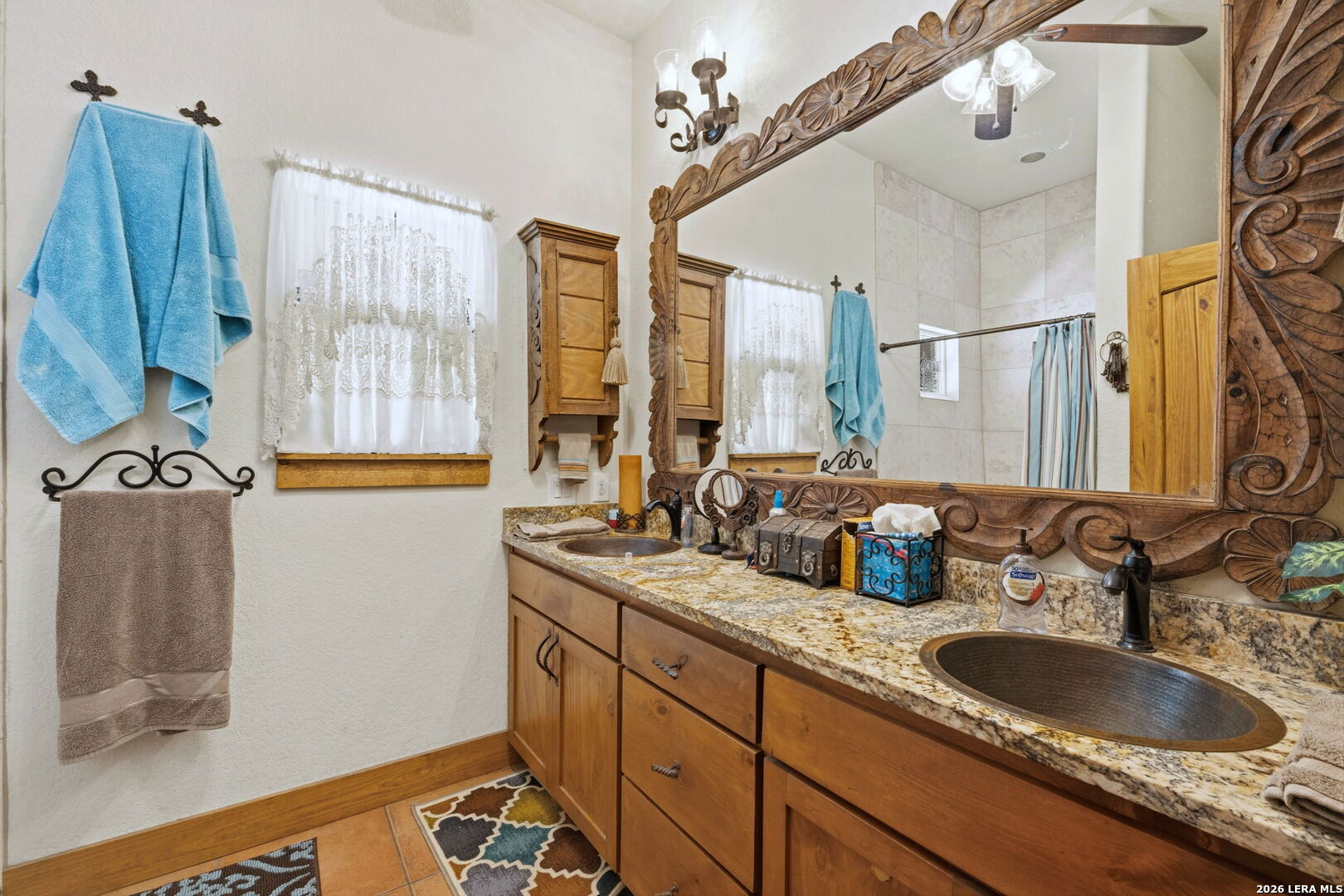 1150 Bruce Road Poteet, TX 78065 - Photo 23 of 33 a bathroom with a sink double vanity and a mirror