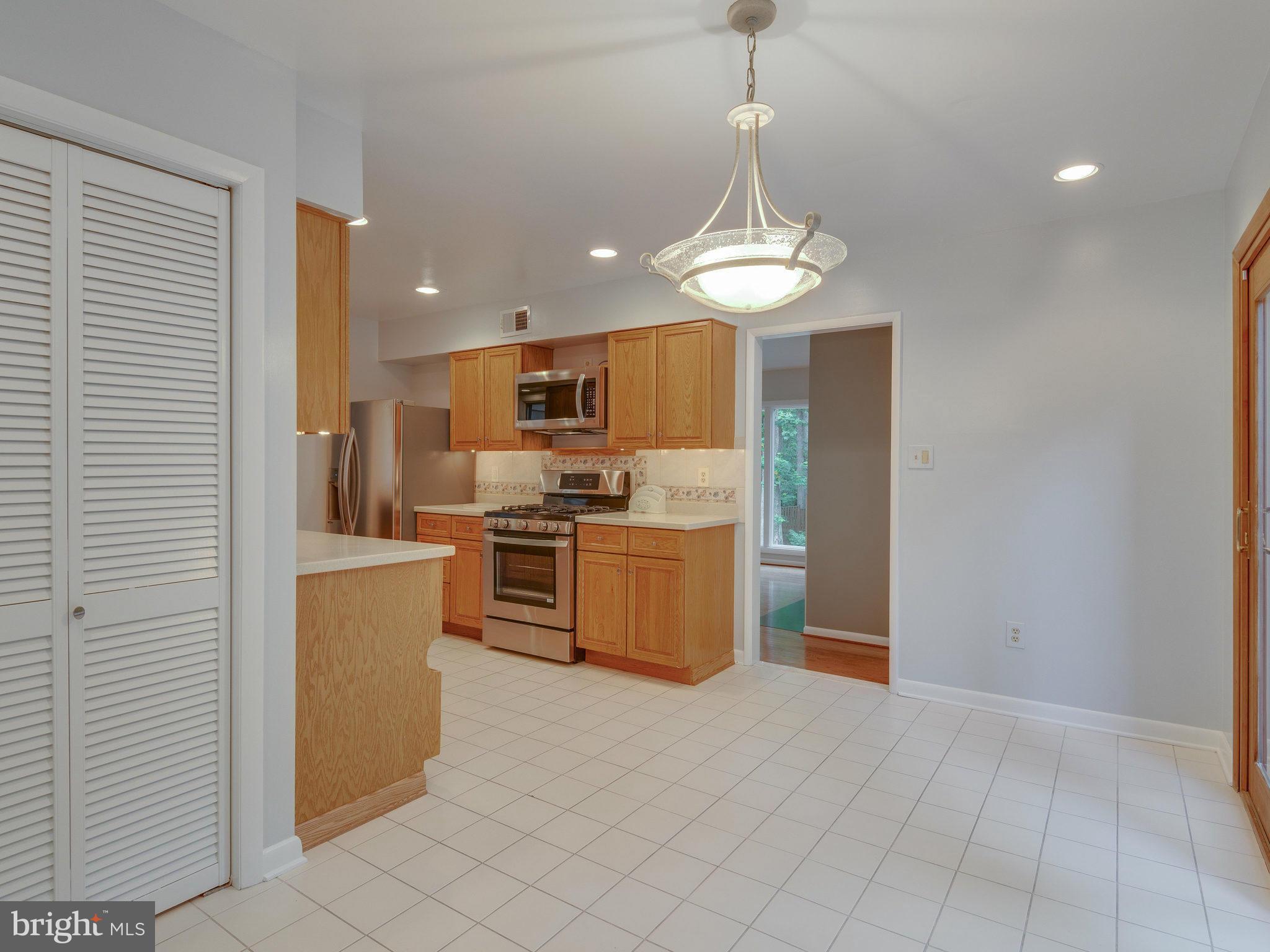 2437 Freetown Drive Reston, VA 20191 - Photo 14 of 30 a kitchen with stainless steel appliances granite countertop a refrigerator a stove a sink and a refrigerator