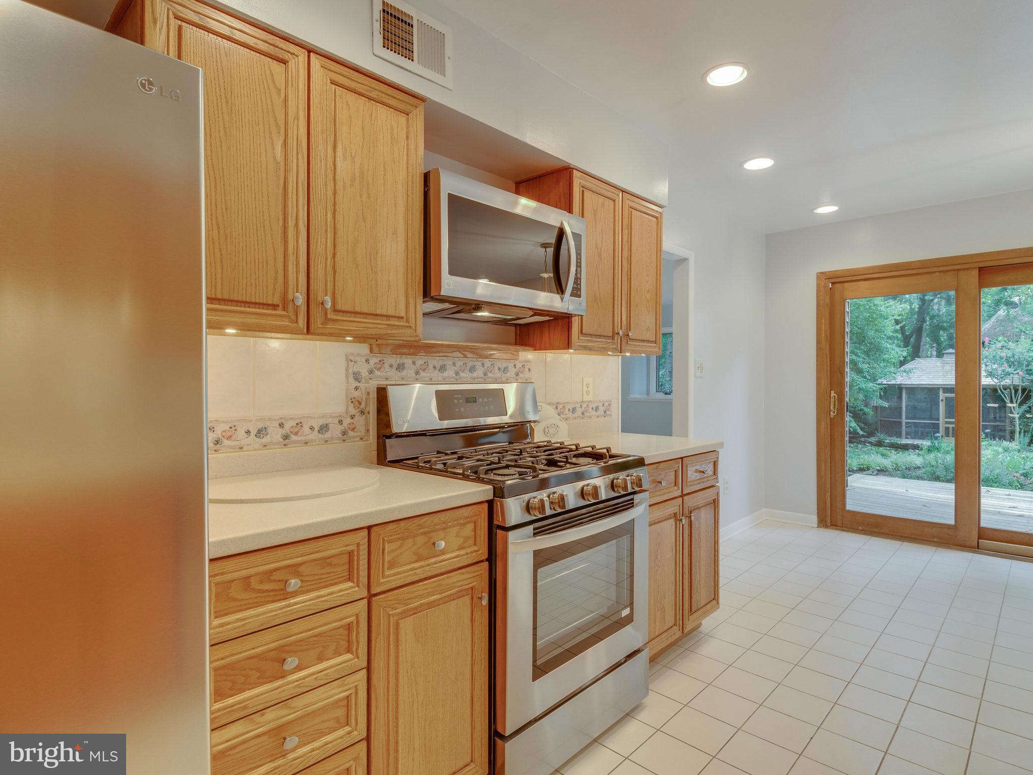 2437 Freetown Drive Reston, VA 20191 - Photo 17 of 30 a kitchen with a stove and a microwave