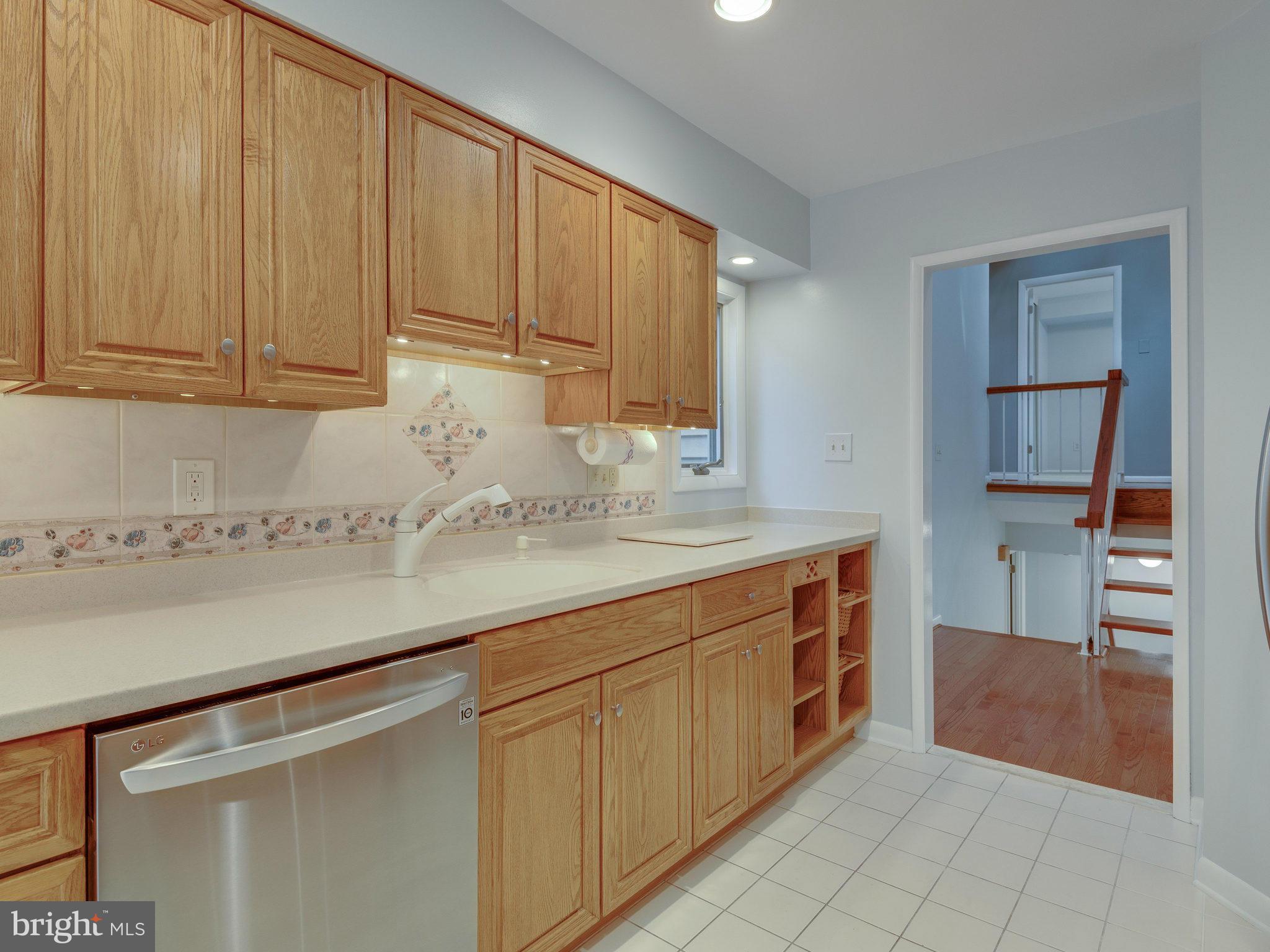 2437 Freetown Drive Reston, VA 20191 - Photo 18 of 30 a kitchen with stainless steel appliances granite countertop a sink and cabinets