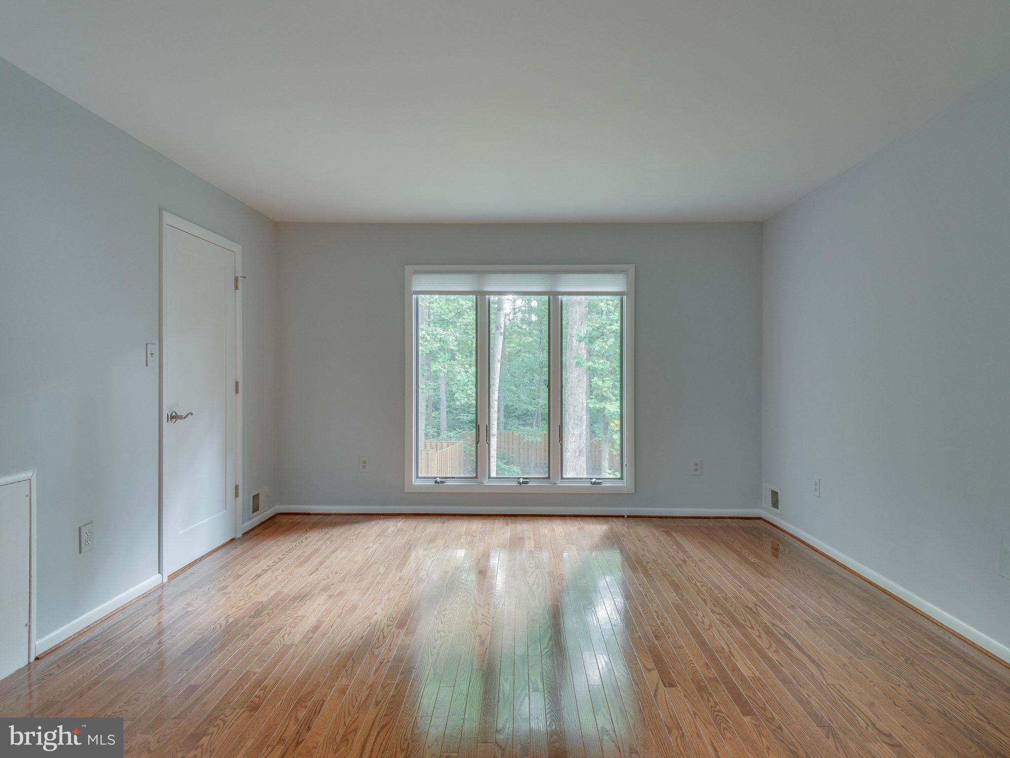 2437 Freetown Drive Reston, VA 20191 - Photo 21 of 30 an empty room with wooden floor and windows