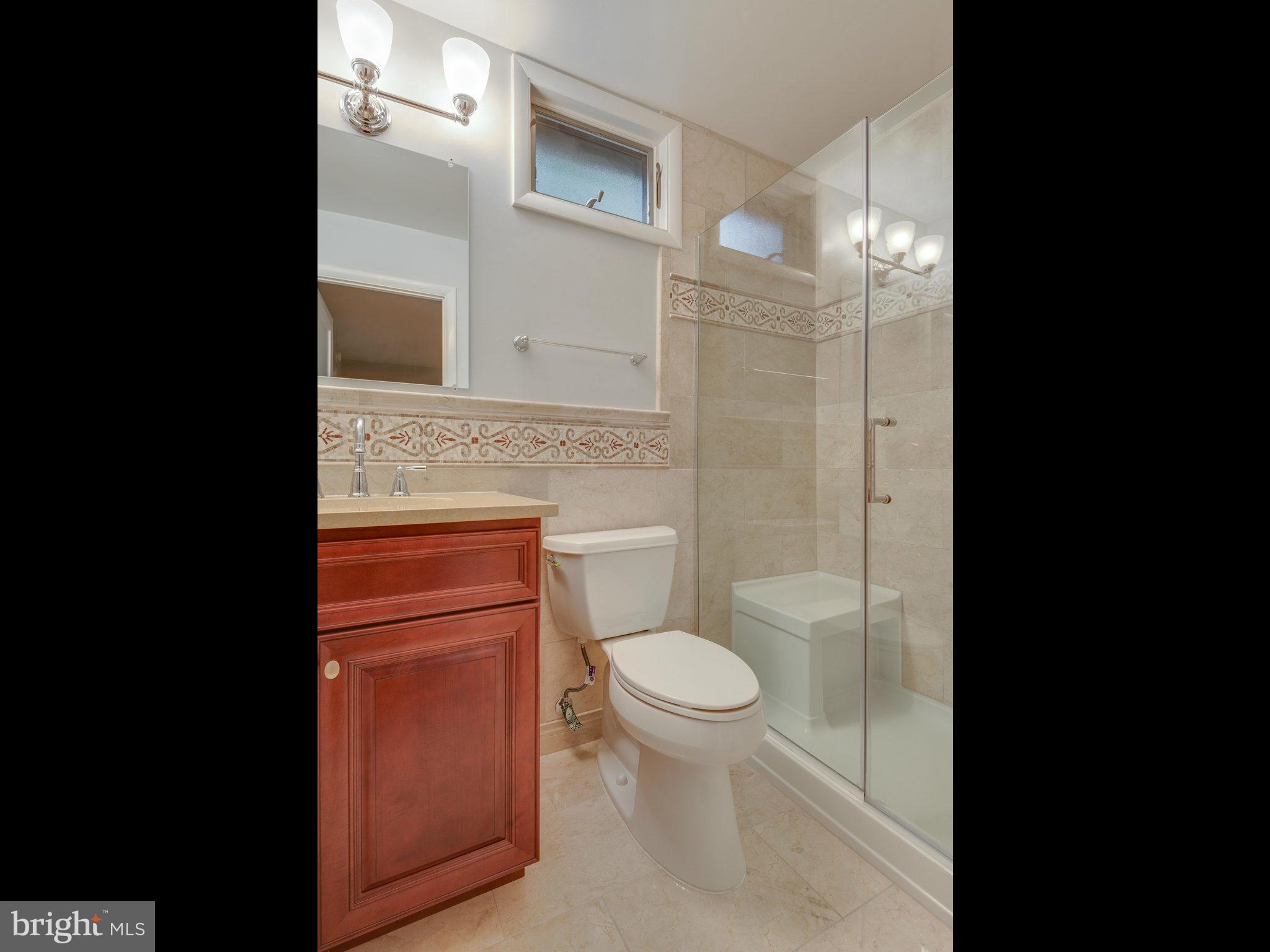 2437 Freetown Drive Reston, VA 20191 - Photo 24 of 30 a bathroom with a toilet a sink and shower