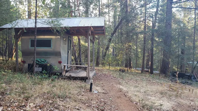 a backyard of a house with table and chairs