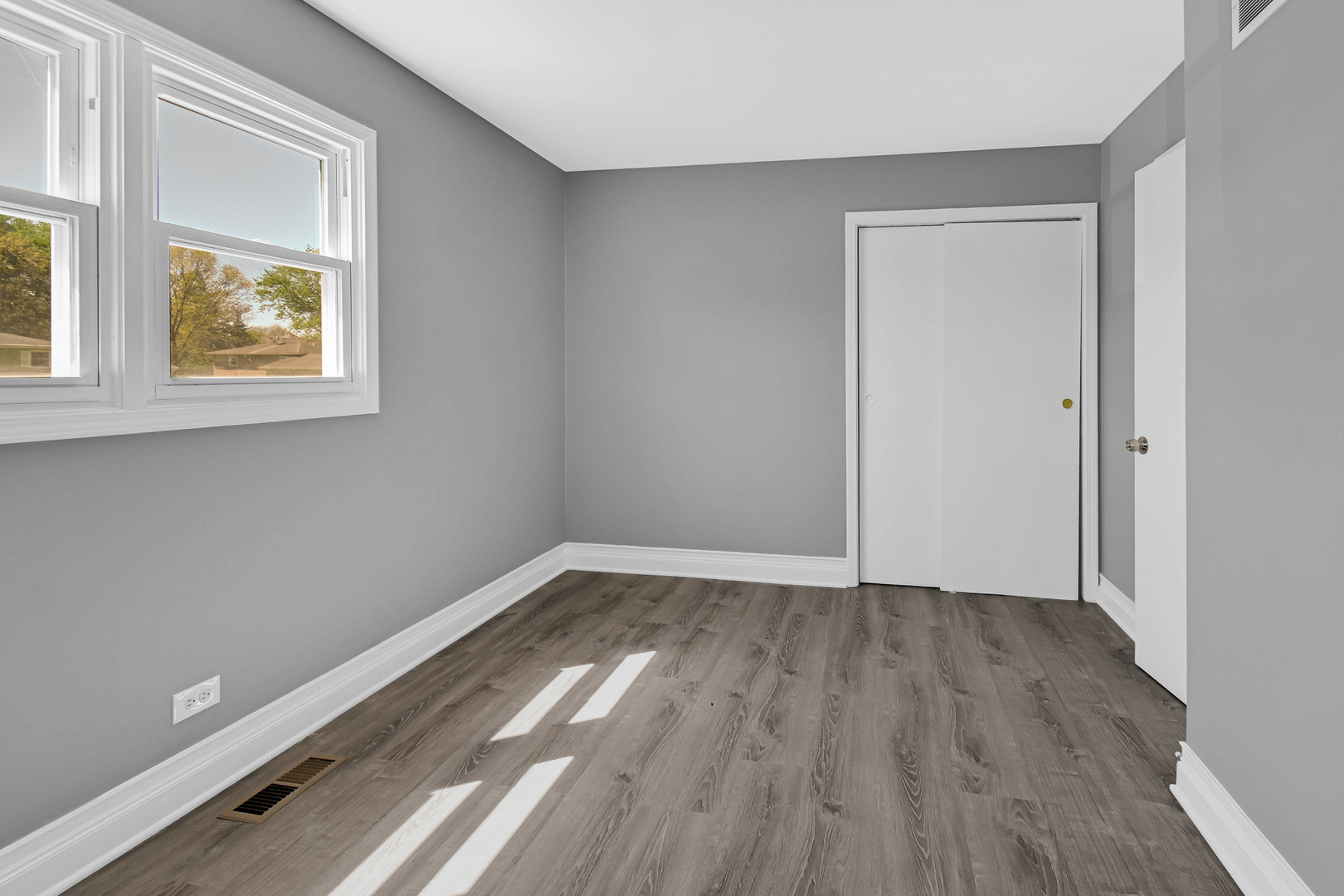 28W502 Leverenz Road Naperville, IL 60564 - Photo 16 of 30 a view of an empty room with wooden floor and a window